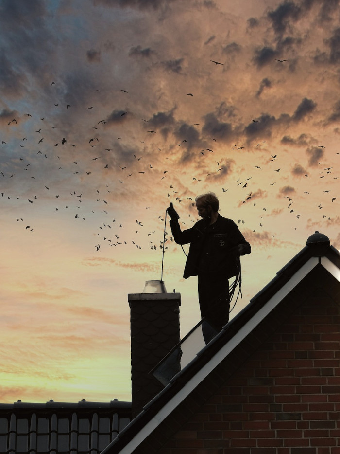 A man cleaning a chimney